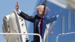 TOPSHOT - US President Donald Trump waves as he boards Air Force One prior to departing from Andrews Air Force Base in Maryland, April 18, 2017, as he travels to Wisconsin. / AFP PHOTO / SAUL LOEB        (Photo credit should read SAUL LOEB/AFP/Getty Images)