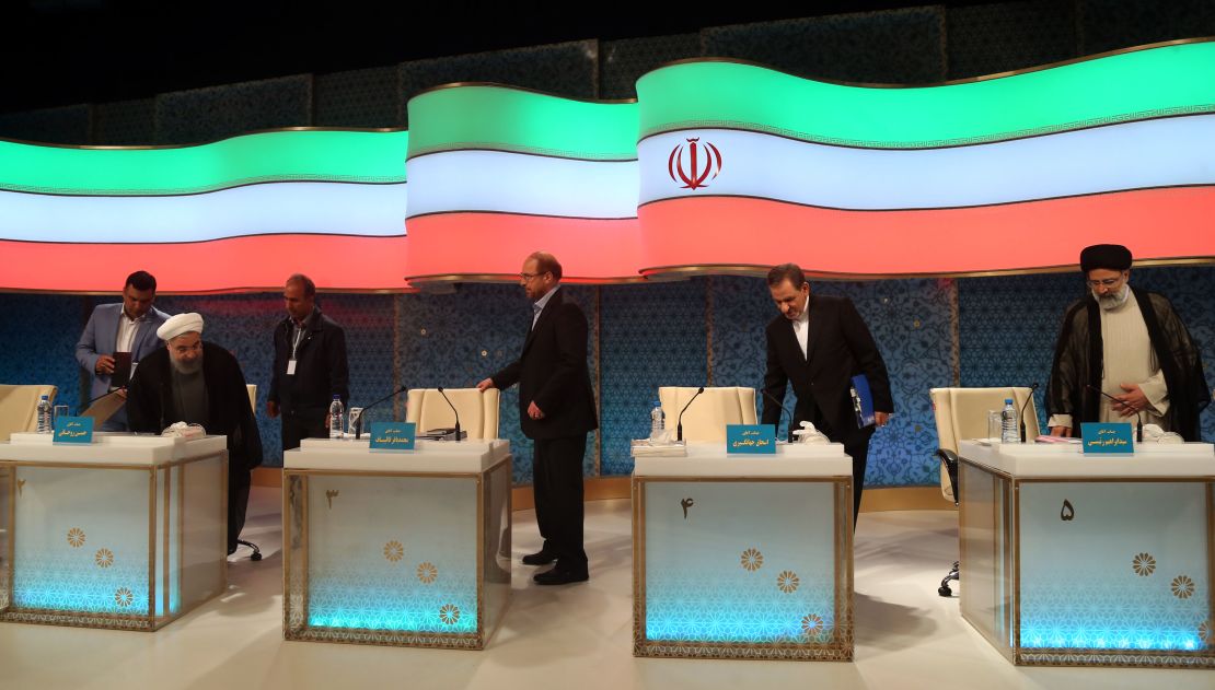 Rouhani (L) and Raisi (R) take their seats for a televised debate in late April.