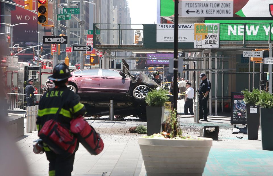 Emergency workers surround the crash site. The motorist, 26-year-old Richard Rojas, has been arrested twice in the past for drunken driving, according to the New York police commissioner.