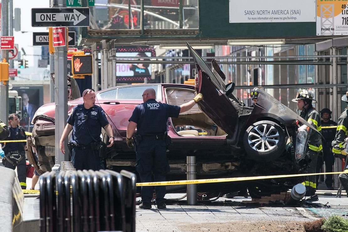  A wrecked car sits in the intersection of 45th and Broadway in Times Square. 