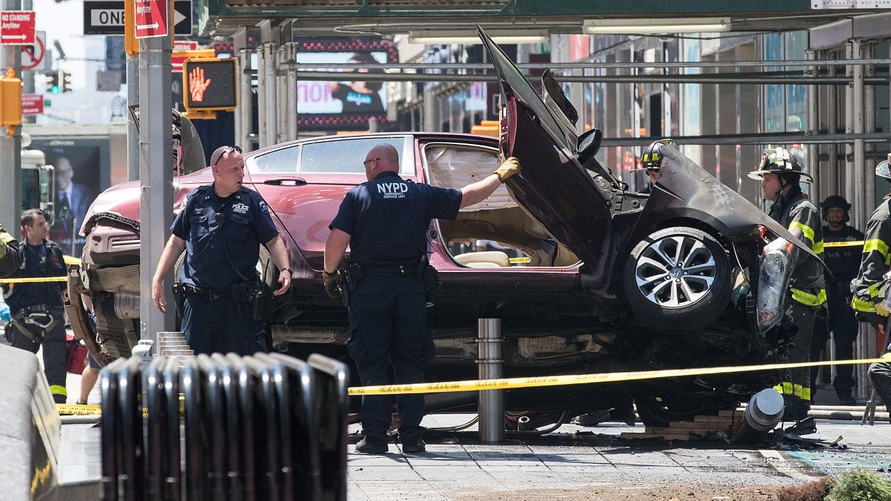  A wrecked car sits in the intersection of 45th and Broadway in Times Square. 