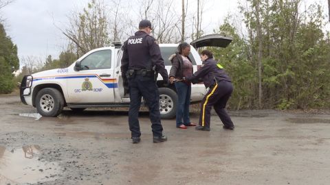 Canadian police detain a Haitian immigrant who just crossed the border.