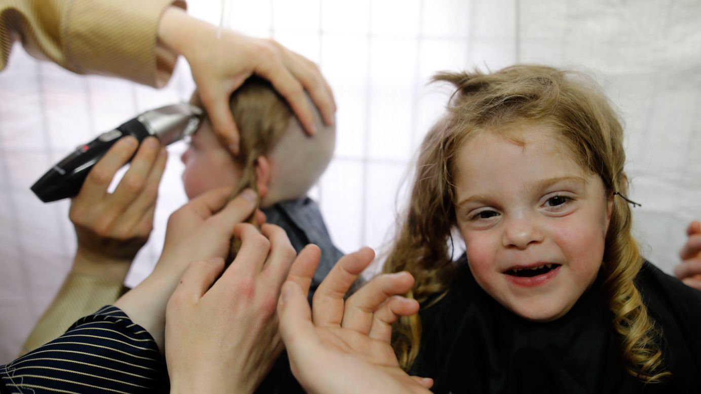 Children in Meron, Israel, take part in a traditional Halake ceremony, getting their first haircuts from their fathers, at the start of the Lag Baomer holiday on Sunday, May 14.