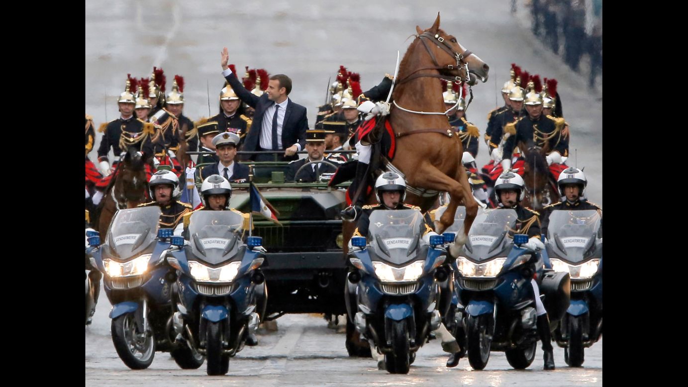<a href="http://www.cnn.com/2017/05/14/europe/emmanuel-macron-france-inauguration/" target="_blank">New French President Emmanuel Macron</a> waves from a military vehicle as he rides toward the Arc de Triomphe in Paris on Sunday, May 14.