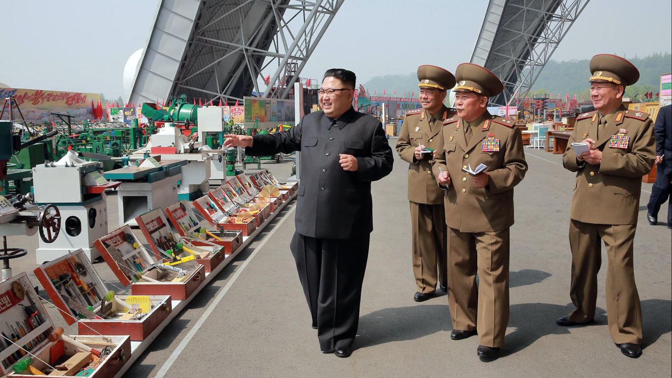 This undated photo, released by North Korea's state-run news agency on Saturday, May 13, shows North Korean leader Kim Jong Un at an exhibition of utensils, tools and other building materials.