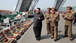 This undated photo released by North Korea's official Korean Central News Agency (KCNA) on May 13, 2017 shows North Korean leader Kim Jong-Un (L) at an exhibition of utensils and tools, finishing building materials and sci-tech achievements organised by the Ministry of the People's Armed Forces.