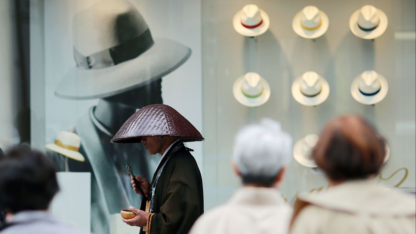 A Buddhist monk offers prayers in Tokyo's Ginza shopping district on Tuesday, May 16.