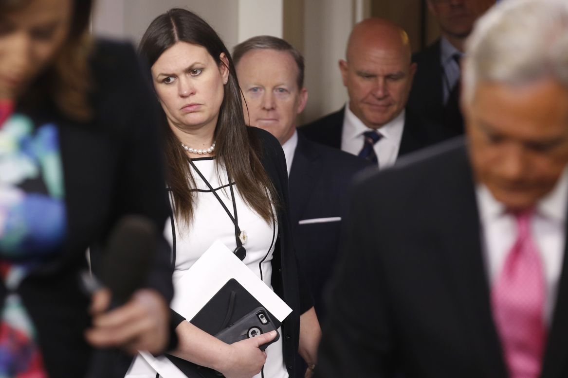 Deputy White House press secretary Sarah Huckabee Sanders holds the door for press secretary Sean Spicer and National Security Adviser H.R. McMaster as they enter the White House briefing room on Tuesday, May 16.