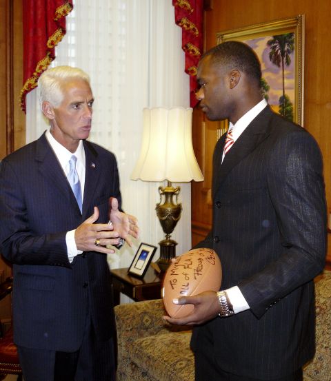 Florida Gov. Charlie Crist presents Rolle with an autographed football inscribed "To Myron -- All Fla. is proud of you," in 2008.