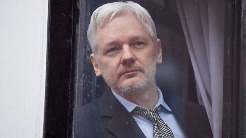 WikiLeaks founder Julian Assange is seen through the window of the door leading to the balcony of the Ecuadorian embassy in central London on February 5, 2016 from where he addressed the media.
During a press conference on February 5 Julian Assange, speaking via video-link, called for Britain and Sweden to "implement" a UN panel finding saying that he should be able to walk free from Ecuador's embassy, where he has lived in self-imposed confinement since 2012. / AFP / BEN STANSALL        (Photo credit should read BEN STANSALL/AFP/Getty Images)