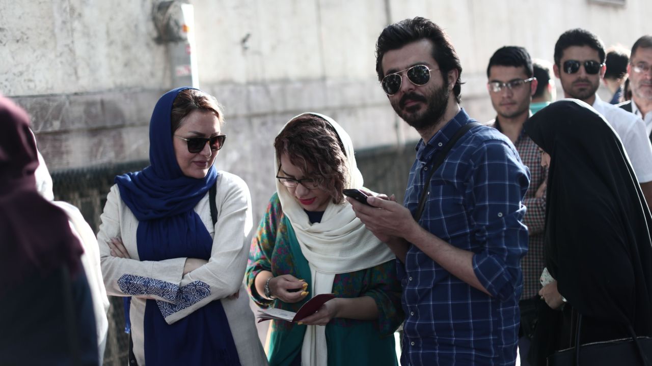 Iranians queue to cast their ballots in presidential elections in Tehran on May 19, 2017.