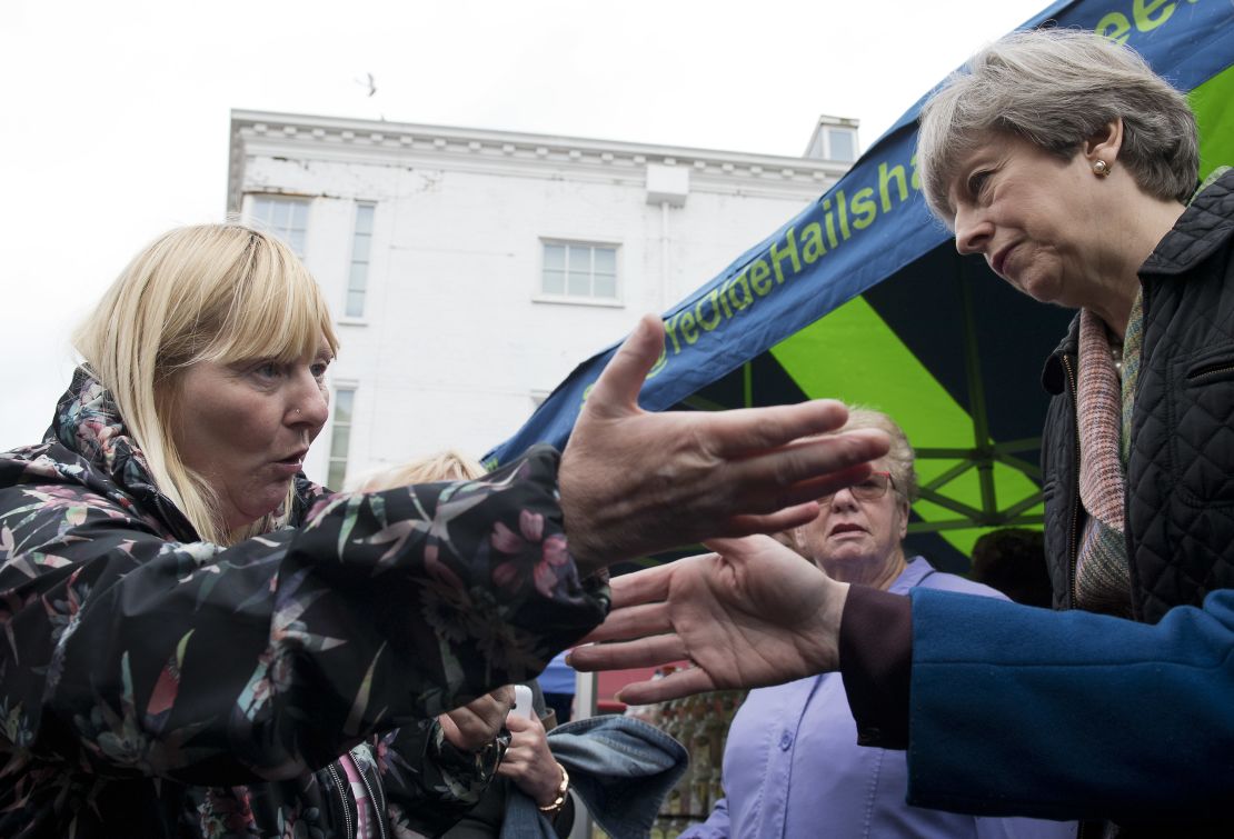 PM Theresa May is confronted by a woman about cuts to her disability benefits during an election campaign walkabout.