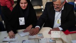 Election officials check people's ID cards at a polling station in Tehran on May 19, 2017.
Iranians head to the polls for a vote that has become a referendum on President Hassan Rouhani's policy of opening up to the world and efforts to rebuild the stagnant economy. / AFP PHOTO / Behrouz MEHRI        (Photo credit should read BEHROUZ MEHRI/AFP/Getty Images)