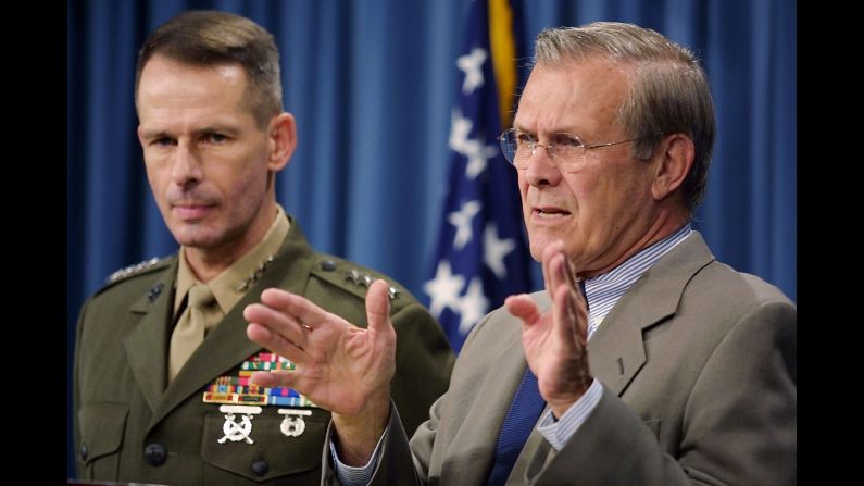 US Defense Secretary Donald Rumsfeld, right, speaks to the press during a Pentagon briefing on November 6, 2001. Rumsfeld said the United States had more than doubled the number of its troops based in Afghanistan. Other countries also contributed troops to the coalition.