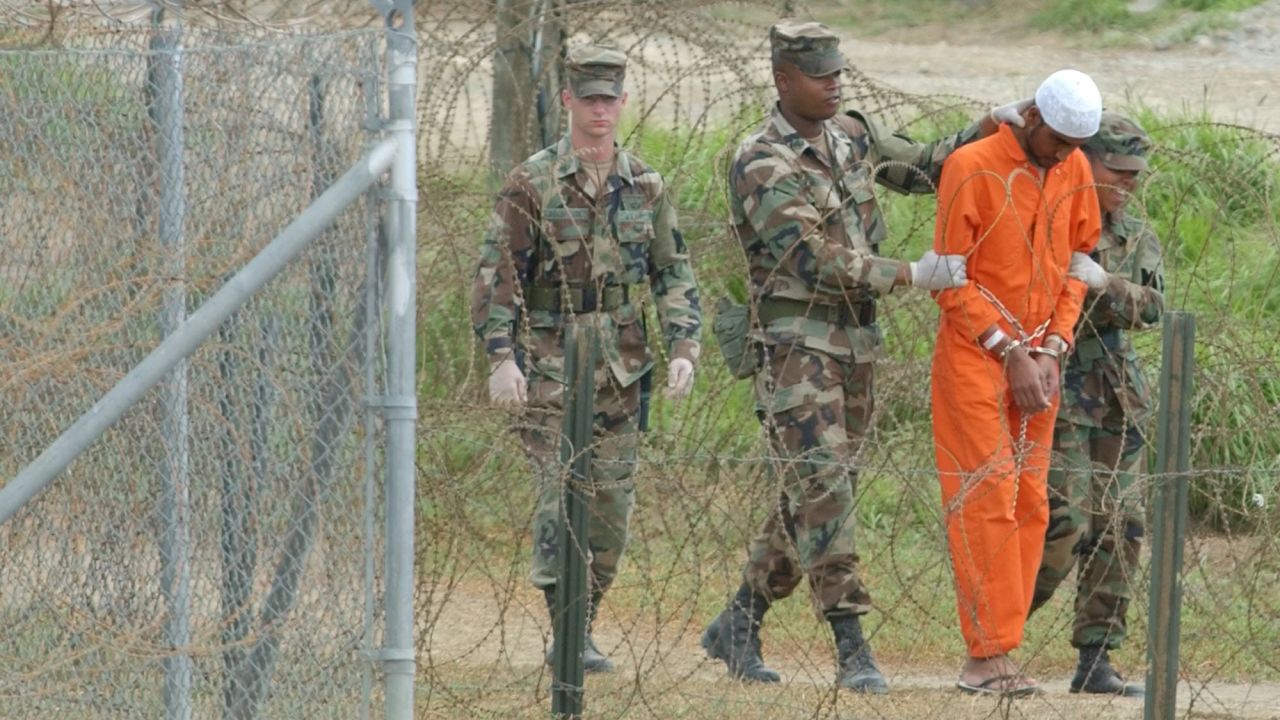 A detainee is escorted by military police at the US naval base in Guantanamo Bay, Cuba, on February 6, 2002. The base's detention facilities had been repurposed to hold detainees from the US "war on terror."