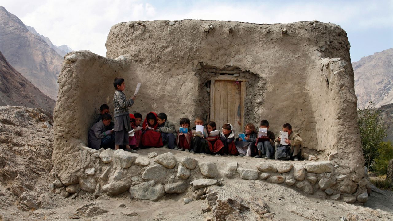Afghan students recite Islamic prayers at an outdoor classroom in the remote Wakhan Corridor on September 2, 2007.