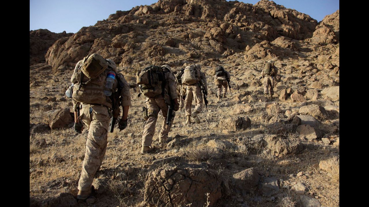 US Marines make their way up a mountainside in Afghanistan's Helmand Province on August 22, 2009.
