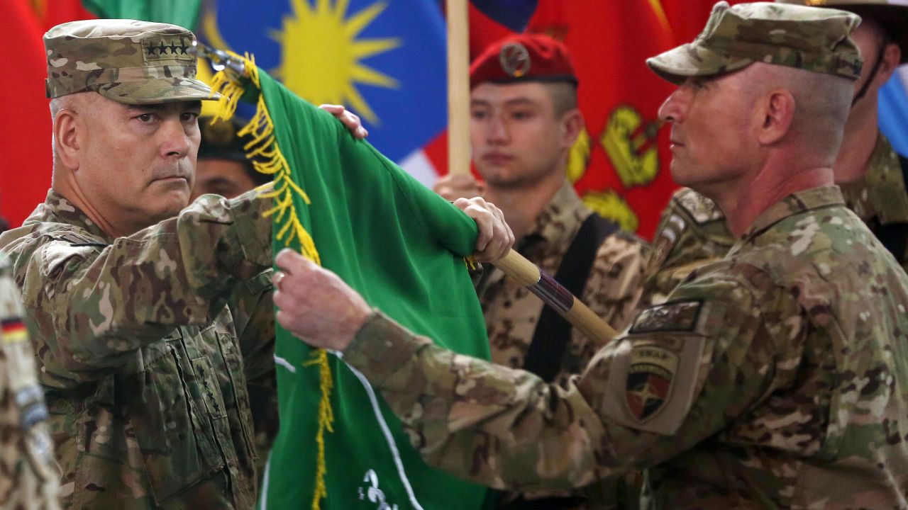 US Army Gen. John Campbell, left, and Command Sgt. Maj. Delbert Byers open the "Resolute Support" flag during a ceremony in Kabul on December 28, 2014. The United States and NATO formally ended the combat mission in Afghanistan. Resolute Support was the name of the new mission to assist and train Afghanistan's troops.