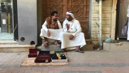 Two merchants sit with their goods in Riyadh's Al-Deera market.