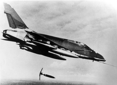 Made by North American Aviation and designed to reach maximum speeds exceeding 925 mph, the F-100 was the first USAF fighter that could fly faster than the speed of sound during level flight. This D model of the F-100 is shown dropping a Snake-Eye bomb on a suspected Viet Cong position in 1966.