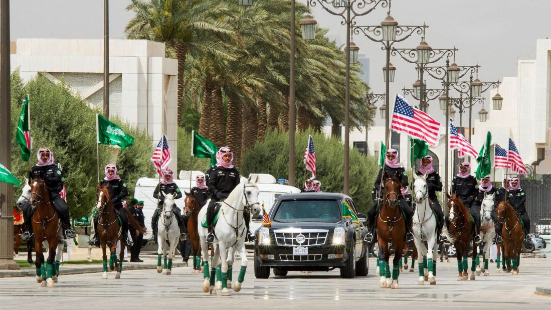 Soldiers on horseback carry the US and Saudi flags as they escort Trump to the Saudi Royal Court in Riyadh.