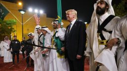 US President Donald Trump joins dancers with swords at a welcome ceremony ahead of a banquet at the Murabba Palace in Riyadh on May 20, 2017. / AFP PHOTO / MANDEL NGAN        (Photo credit should read MANDEL NGAN/AFP/Getty Images)