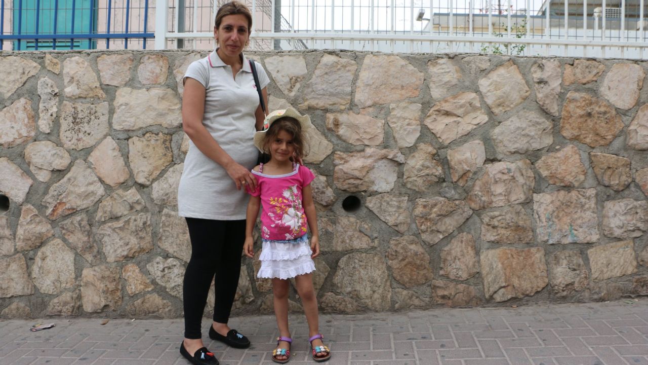 Yara Bahar, 36 and her daughter Rujina, 5, on the Jerusalem side of Checkpoint 300.