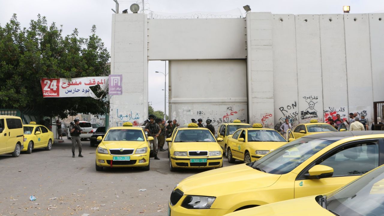 Taxis wait outside Checkpoint 300 in Bethlehem.