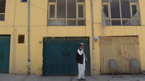 An Afghan man talks on a phone in front an international guest house that was attacked by gunmen in Kabul on Sunday.