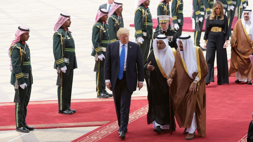 US President Donald Trump is welcomed by Saudi King Salman bin Abdulaziz al-Saud upon arrival at King Khalid International Airport in Riyadh on May 20, 2017, followed by first lady Melania Trump. 