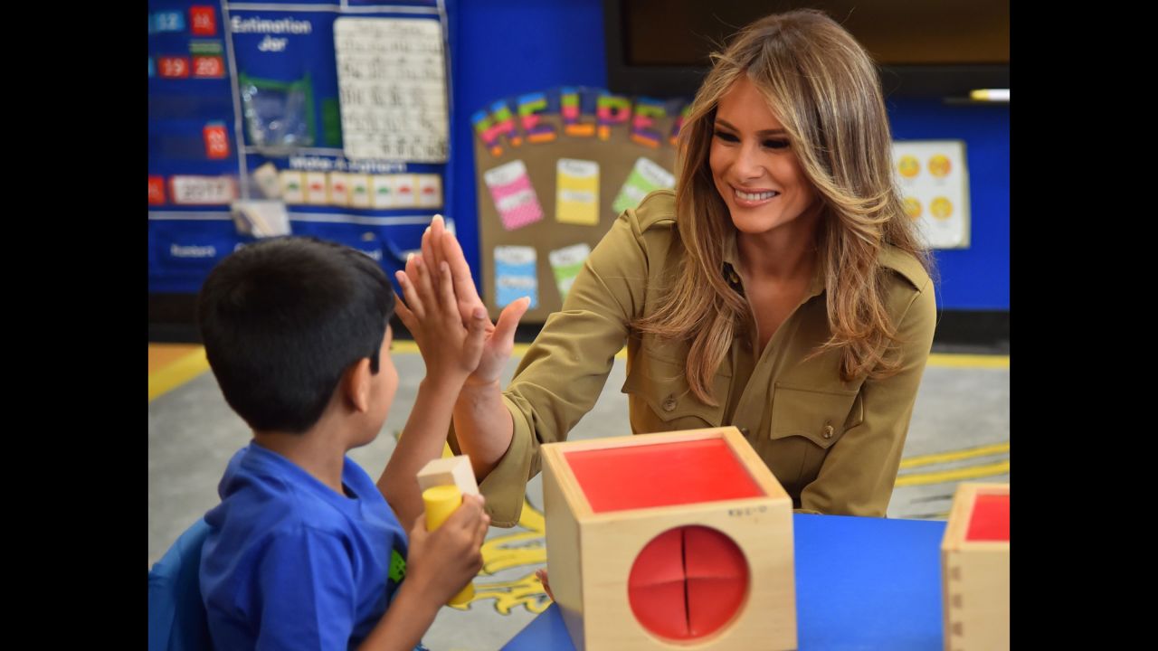 The first lady high-fives a child during a visit to the American International School in Riyadh, Saudi Arabia.
