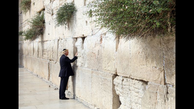Trump touches the Western Wall, Judaism's holiest prayer site, while in Jerusalem on May 22. Trump became <a href="index.php?page=&url=http%3A%2F%2Fwww.cnn.com%2F2017%2F05%2F22%2Fpolitics%2Ftrump-israel-western-wall%2F" target="_blank">the first sitting US president to visit the wall.</a>