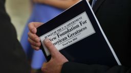 White House budget director Mick Mulvaney, holds a copy of "Budget of the U.S. Government A New Foundation For American Greatness Fiscal Year 2018" as he inspects the production run of President Donald Trump's fiscal 2018 federal budget, Friday, May 19, 2017, at the U.S. Government Publishing Office's (GPO) plant in Washington. (AP Photo/Carolyn Kaster)