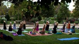 Men and women take part in an exercise class in a public park in Barcelona, Wednesday, July 20, 2011. (AP Photo/Emilio Morenatti)