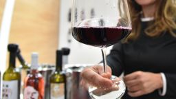 A woman hands a glass of wine from the "Le Moire" wine maker of the Italian Calabria region on April 10, 2016 during the 50th edition of the Vinitaly wine exhibition in Verona.

Vinitaly is the worlds largest wine event, hosting  more than 4164 exhibitors, looking to promote a vast range of rich and exotic varieties of wines, spirits and other alcoholic beverages.
 / AFP / VINCENZO PINTO        (Photo credit should read VINCENZO PINTO/AFP/Getty Images)