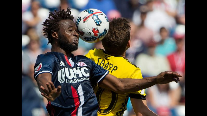 New England midfielder Xavier Kouassi, left, heads the ball during a Major League Soccer match against Columbus on Sunday, May 21.