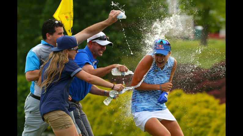 Lexi Thompson is sprayed with water on the 18th green after winning the Kingsmill Championship, an LPGA tournament in Williamsburg, Virginia, on Sunday, May 21. She went wire to wire and shot a tournament record 264 (20-under).