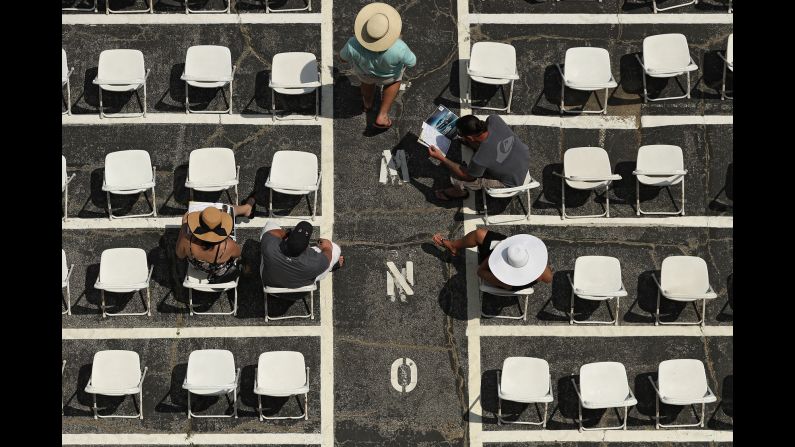 Fans sit in the grandstand before the Black-Eyed Susan Stakes, a horse race at Baltimore's Pimlico Race Course on Friday, May 19.