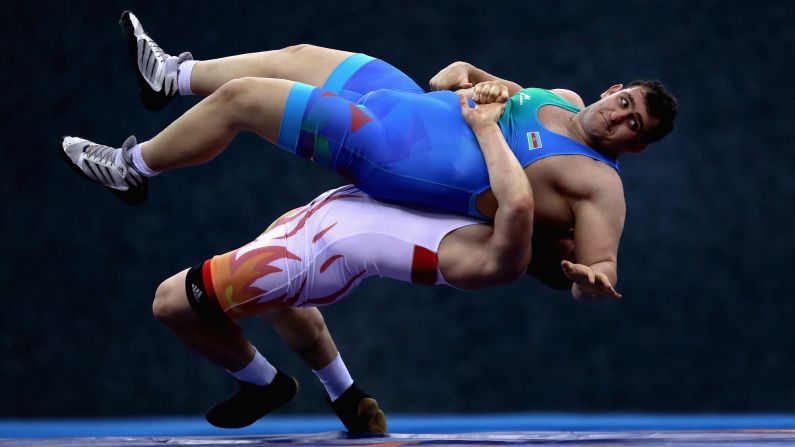 Azerbaijan's Sabah Shariati is thrown by Uzbekistan's Muminjon Abdullaev during a wrestling match at the Islamic Solidarity Games on Thursday, May 18.
