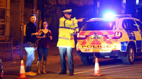 Police stand near a cordoned-off street close to the Manchester Arena on May 22.