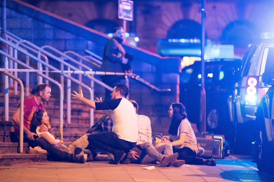 People sit outside near the arena. The crowd was made up of mainly younger people who had come to see Grande in her first of three scheduled concerts in the UK.