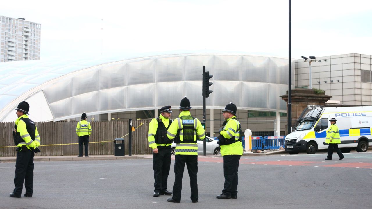 Police officers stand outside the Manchester Arena a day after the bombing there.