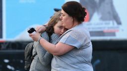 MANCHESTER, UNITED KINGDOM - MAY 23: Walking casualties Vikki Baker and her thirteen year old daughter Charlotte hug outside the Manchester Arena stadium in Manchester, United Kingdom on May 23, 2017. A large explosion was reported at the end of a concert by American singer Ariana Grande. So far, police have confirmed 20 dead and over fifty injured in the explosion, now thought to be terrorist-related.  (Photo by Lindsey Parnaby/Anadolu Agency/Getty Images)