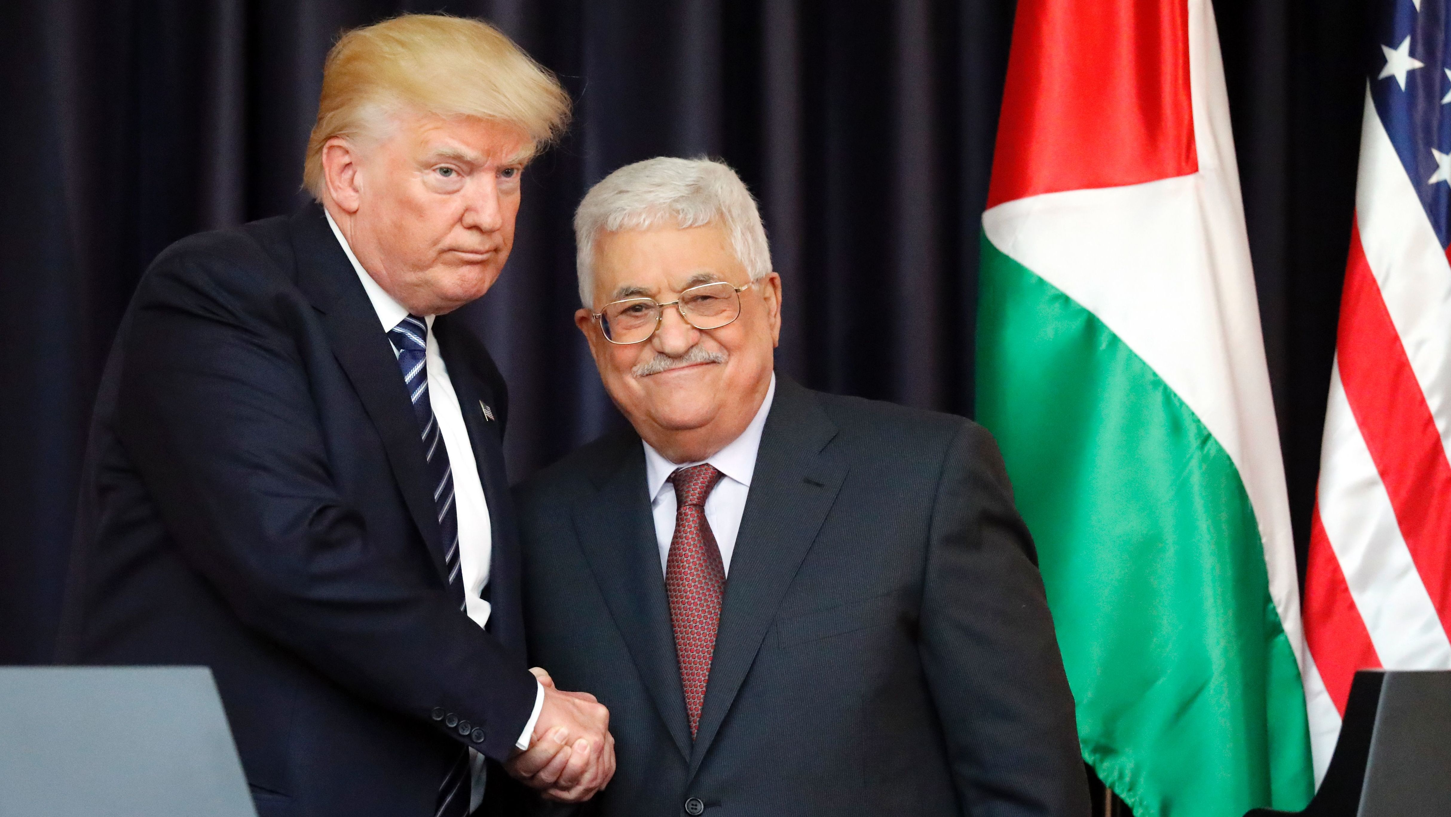 US President Donald Trump, left, and Palestinian leader Mahmoud Abbas shake hands at the presidential palace in  Bethlehem on May 23, 2017.