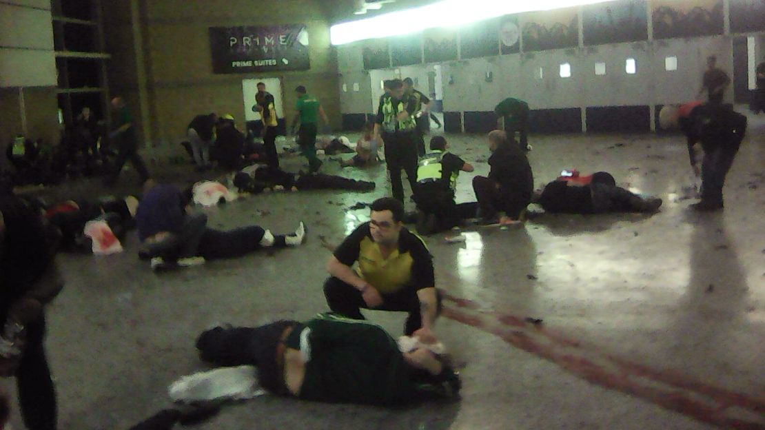 Helpers attend to injured people at Manchester Arena on Monday night.