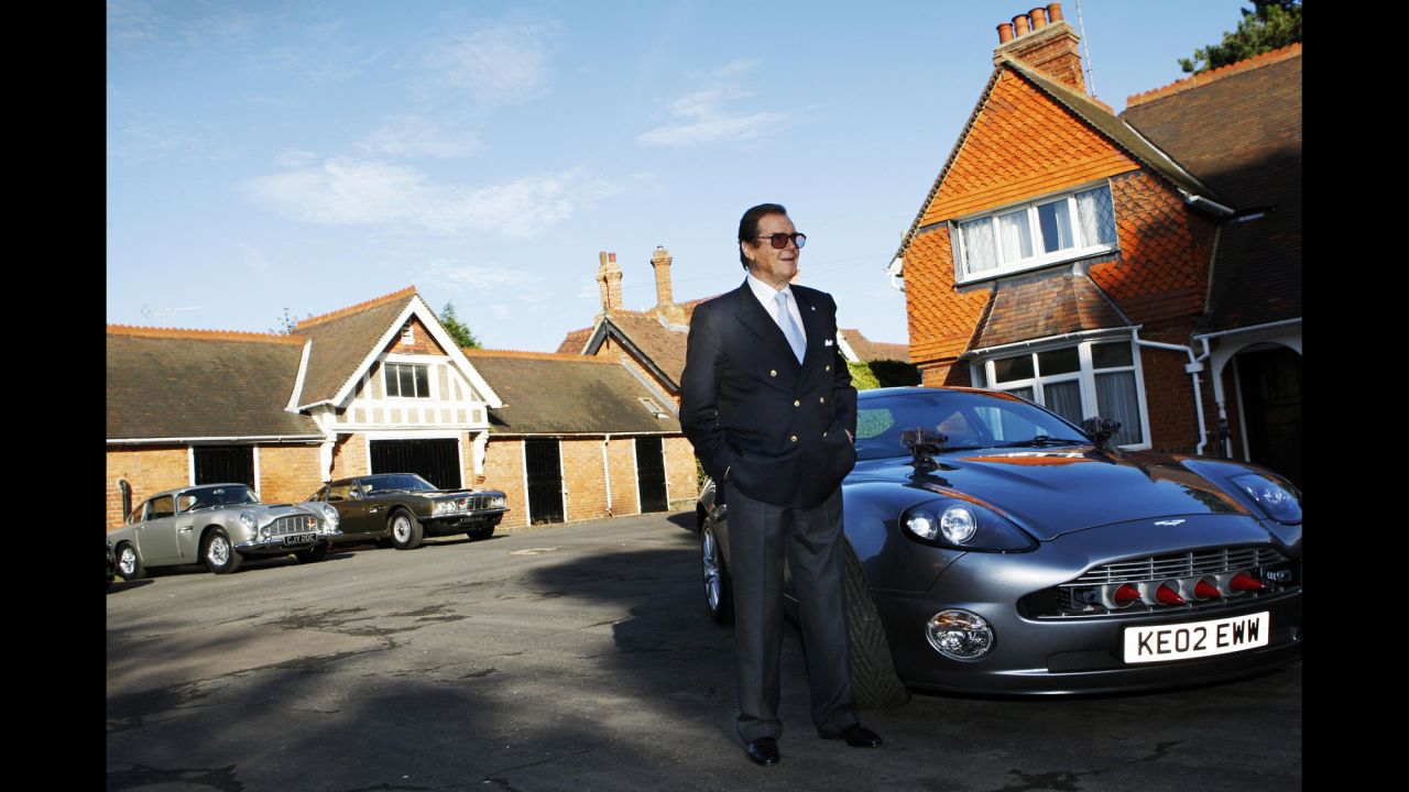 Moore stands beside an Aston Martin during a photo shoot in Milton Keynes, England, in 2008.
