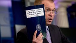 Budget Director Mick Mulvaney holds up a copy of President Donald Trump's proposed fiscal 2018 federal budget as he speaks to members of the media in the Press Briefing Room of the White House in Washington, Tuesday, May 23, 2017. (AP Photo/Andrew Harnik)