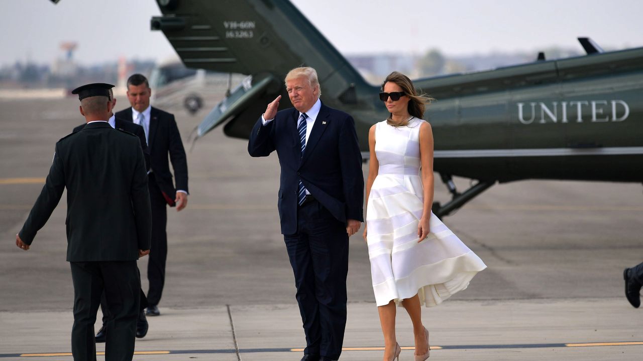 US President Donald Trump and First Lady Melania Trump make their way to board Air Force One before departing from Ben Gurion International Airport in Tel Aviv on May 23, 2017.
