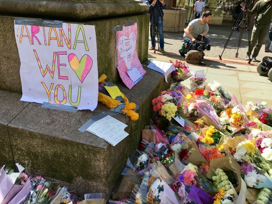 Flowers and messages of support are left in Manchester's St Ann's Square in tribute to the 22 people who died in an attack at an Ariana Grande concert on Monday night.