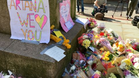 Flowers and messages of support are left in Manchester's St Ann's Square in tribute to the 22 people who died in an attack at an Ariana Grande concert on Monday night.